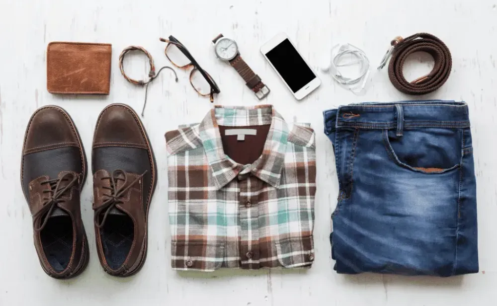 Men's casual outfits with man clothing and accessories on rustic wooden background, travel concept